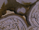 Dark, reddish-brown circles. One terrain on Mars wins the weirdness award: the South Polar residual cap. The residual cap (what’s left by middle to late summer) is composed of carbon dioxide ice (dry ice) over layers of water ice. The carbon dioxide ice sublimates rapidly in the summer from these dark slopes, causing slope retreat. This makes the “holes” in the “Swiss cheese.” In this scene there are several big holes, and inside them is a newer layer being sublimated to form smaller holes.